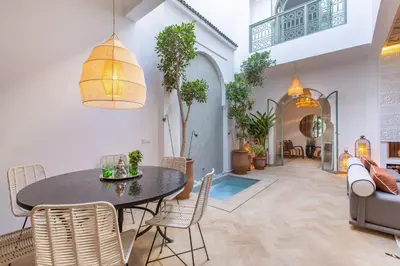 a dining room with a table and chairs at Dar KAJAM -Privatized Riad -10mn from Jamaa Al Fna in Marrakech