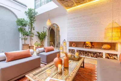 a living room with two couches and a fireplace at Dar KAJAM -Privatized Riad -10mn from Jamaa Al Fna in Marrakech