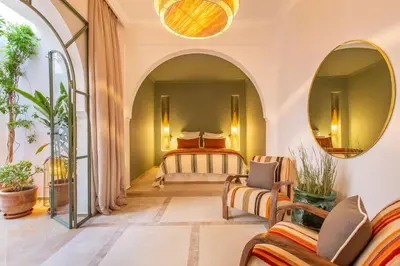 a bedroom with a bed and two mirrors at Dar KAJAM -Privatized Riad -10mn from Jamaa Al Fna in Marrakech