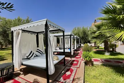 a group of four beds in a gazebo at Villa Sahar in Marrakech