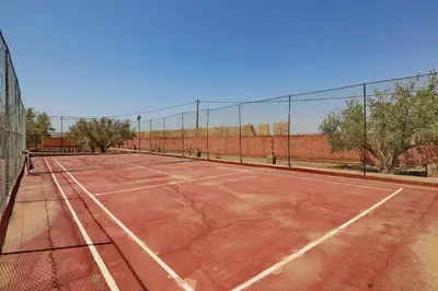 an empty tennis court with a fence on it at Villa Sahar in Marrakech