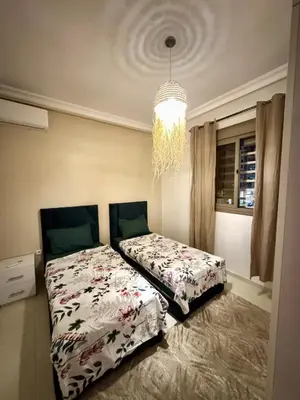 a bedroom with a bed and a chandelier at Marrakech Airport Appart in Marrakech