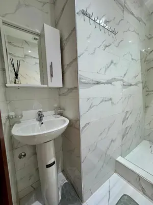 a white bathroom with a sink and a shower at Marrakech Airport Appart in Marrakech