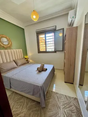 a bedroom with a bed and a window at Marrakech Airport Appart in Marrakech