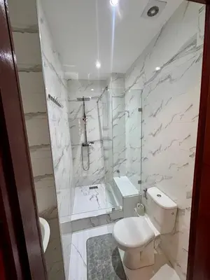 a white bathroom with a toilet and a shower at Marrakech Airport Appart in Marrakech