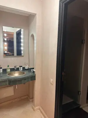a bathroom with a sink and a mirror at Appartement meublé à River palm in Marrakech