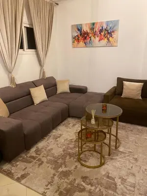 a living room with a couch and a table at Apparemment tout confort in Marrakech