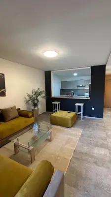 a living room with a couch and a table in a room at Center appartement Marrakech in Marrakech