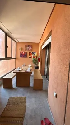 a large room with tables and benches in a building at Center appartement Marrakech in Marrakech