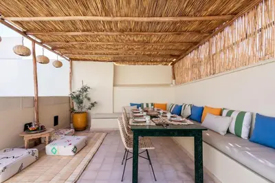 a living room with a table and a couch at Riad BAB 19 in Marrakech