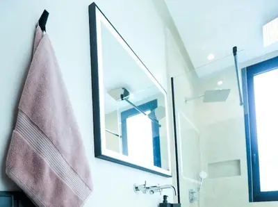 a bathroom with a sink and a mirror and a towel at VILLA Wa EXCLUSIVE MARRAKECH in Marrakech