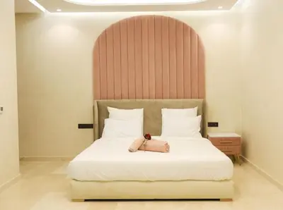 a bed with a purse sitting on top of it at VILLA Wa EXCLUSIVE MARRAKECH in Marrakech