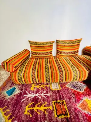 a colorful bed with two pillows on top of it at Maison Cascada 2 in Marrakech
