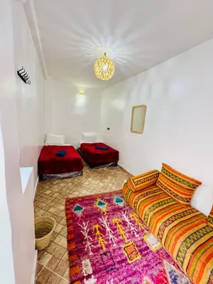 a bedroom with two beds and a rug at Maison Cascada 2 in Marrakech