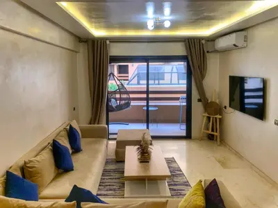 a living room with a couch and a table at Chic appartement marrakech in Marrakech