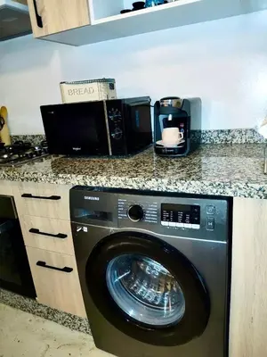 a kitchen counter with a washing machine in a kitchen at Chic appartement marrakech in Marrakech