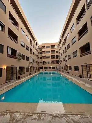 a large swimming pool in the middle of a building at Chic appartement marrakech in Marrakech