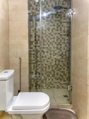 a bathroom with a toilet and a glass shower at Chic appartement marrakech in Marrakech