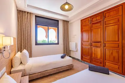 a bedroom with a bed and a window at Villa Riad Targa 10 min de GUELIZ Piscine privee in Marrakech