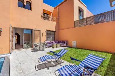 a patio with chairs and a table and a couch at Villa Riad Targa 10 min de GUELIZ Piscine privee in Marrakech
