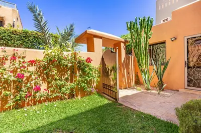 a gate to a house with flowers and plants at Villa Riad Targa 10 min de GUELIZ Piscine privee in Marrakech