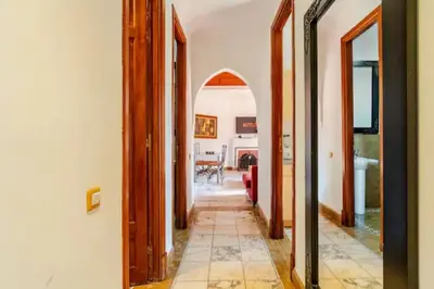 a hallway of a house with an archway in it at NATURALapartmentLARGE pool in Marrakech