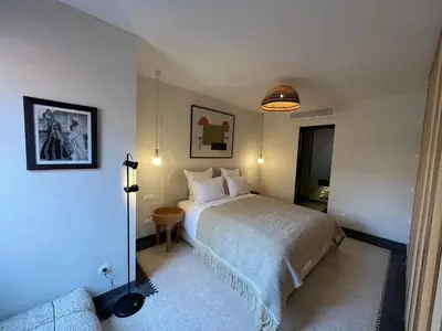 a bedroom with a bed and a couch at Appartement Élégant et Spacieux Près de Carré Eden in Marrakech