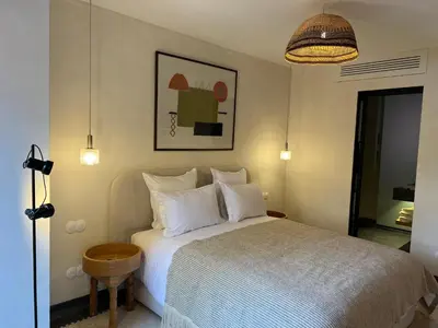 a bedroom with a bed with white pillows at Appartement Élégant et Spacieux Près de Carré Eden in Marrakech