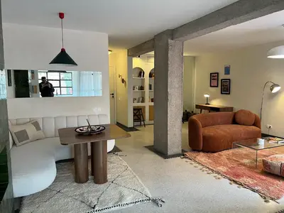 a living room with a couch and a table at Appartement Élégant et Spacieux Près de Carré Eden in Marrakech