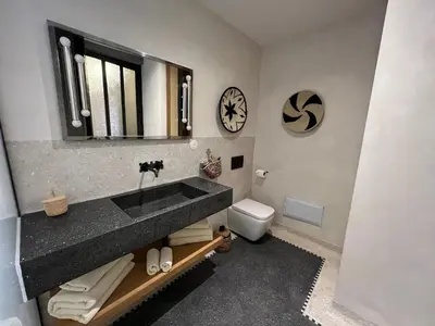 a bathroom with a sink and a mirror and a toilet at Appartement Élégant et Spacieux Près de Carré Eden in Marrakech