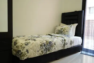 a bedroom with a bed with a blanket and pillows at Bayt Al Atlas in Marrakech
