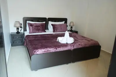 a bed with a stuffed animal sitting on top of it at Bayt Al Atlas in Marrakech
