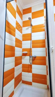 a shower with orange and white stripes at Bayt Al Atlas in Marrakech