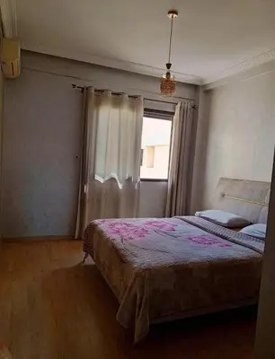 a bedroom with a large bed and a window at Maison lala in Marrakech