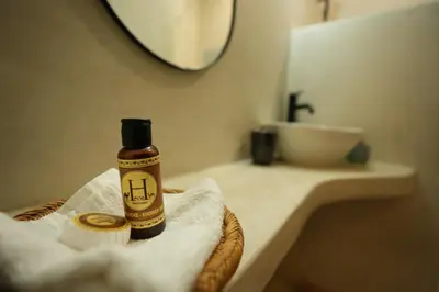 a bathroom with a bottle of alcohol on a towel at Romantic getaway heart of Gueliz in Marrakech