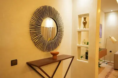 a round mirror on a wall in a room at Romantic getaway heart of Gueliz in Marrakech