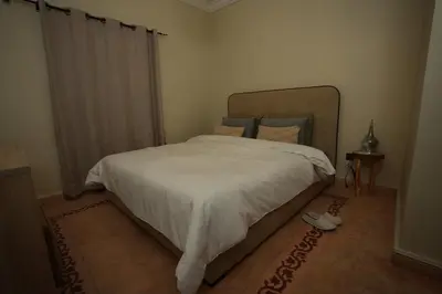 a bedroom with a bed with a white comforter at Romantic getaway heart of Gueliz in Marrakech