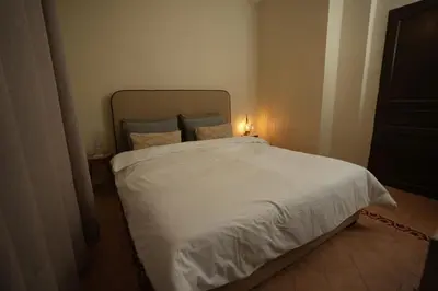 a bedroom with a white bed with a light on it at Romantic getaway heart of Gueliz in Marrakech