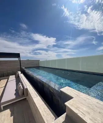 a swimming pool on the side of a building at Superbe Duplex piscine chauffée in Marrakech