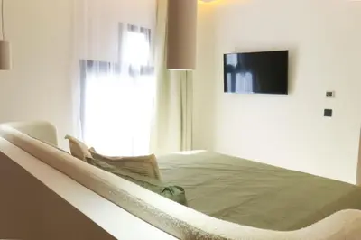 a bed sitting in a room with a window at Superbe Duplex piscine chauffée in Marrakech