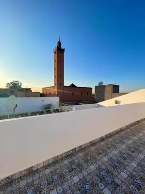 a view from the roof of a building with a clock tower at Gîte Familial Aïcha in El Gouassem