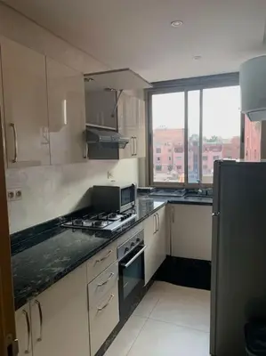 a kitchen with white cabinets and a large window at 2-Bedroom Apart, Heart of Gueliz in Marrakech