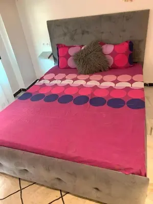 a large pink bed with pink and blue pillows at 2-Bedroom Apart, Heart of Gueliz in Marrakech