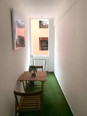 a room with a table and two chairs and a green floor at 2-Bedroom Apart, Heart of Gueliz in Marrakech
