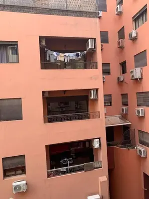 an apartment building with clothes hanging out the window at 2-Bedroom Apart, Heart of Gueliz in Marrakech