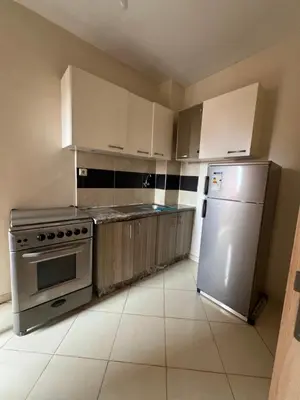 a kitchen with white cabinets and a stainless steel refrigerator at Location Familiale Marrakech 2 in Marrakech