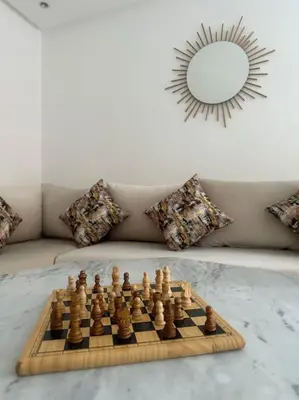 a chess board on a table in a room with a mirror at Luxueuse villa au Golf Amelkis - 5 suites in Marrakech