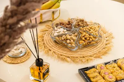 a table with a plate of nuts and other foods at Luxury Apartment 3 Bedroom in CityCenter Marrakech in Marrakech