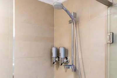 a shower with a shower head in a bathroom at Luxury Apartment 3 Bedroom in CityCenter Marrakech in Marrakech