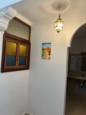 a chandelier hanging in a room with a window at Habibi Riad&Hostel in Marrakech